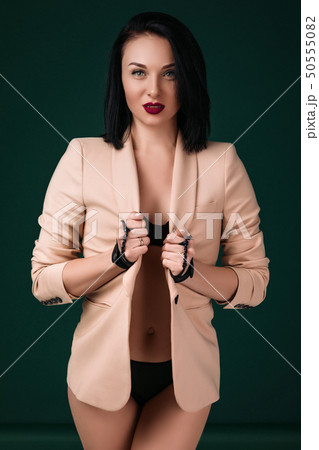 woman in black sexy lingerie and beige jacket posing 50555082