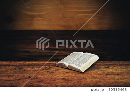 Bible on a old wooden table background. Bible on a old wooden table background. 50556468