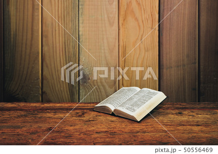 Bible on a old wooden table background. Bible on a old wooden table background. 50556469
