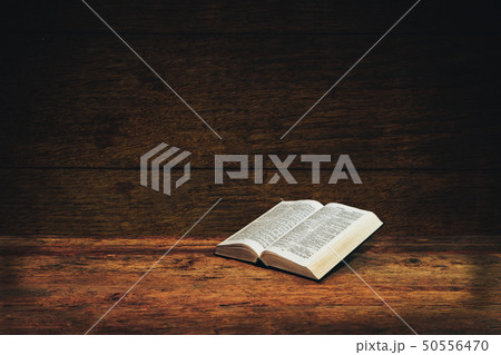 Bible on a old wooden table background. Bible on a old wooden table background. 50556470
