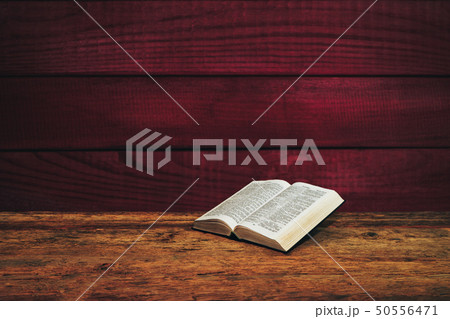 Bible on a old wooden table background. 50556471
