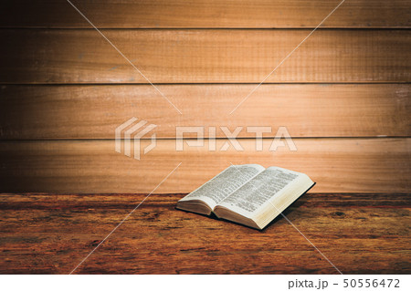 Bible on a old wooden table background. Bible on a old wooden table background. 50556472