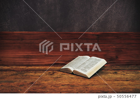 Bible on a old wooden table background. Bible on a old wooden table background. 50556477