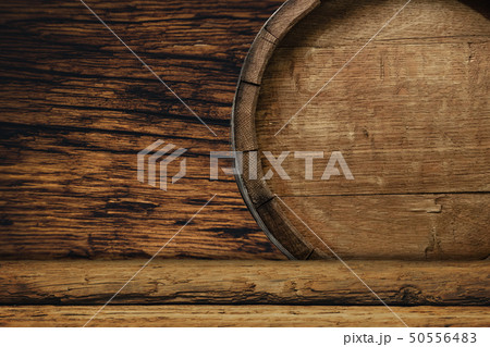 Wooden barrel and worn old table of wood. 50556483