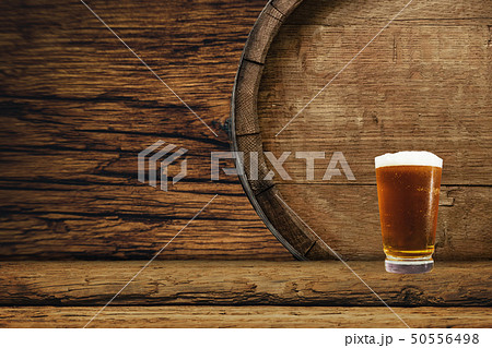 Wooden barrel and glass of beer on a old oak table 50556498