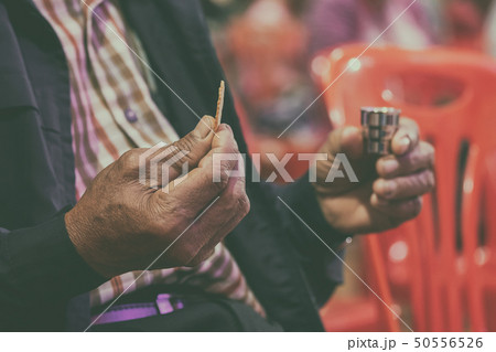 Faithful Asian Elder Praying in the Holy Communion 50556526