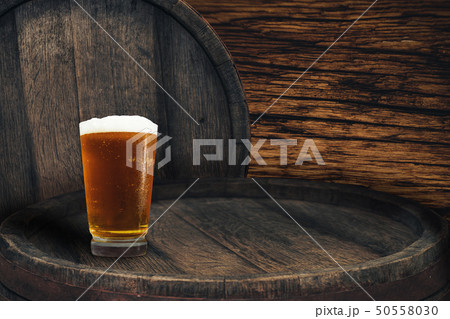 Wooden barrel and glass of beer on a barrel table 50558030
