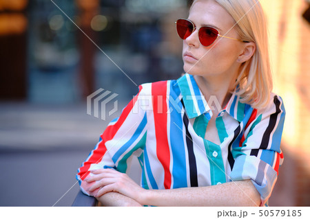 Freckled girl is walking in the city streets Freckled girl is walking in the city streets 50579185