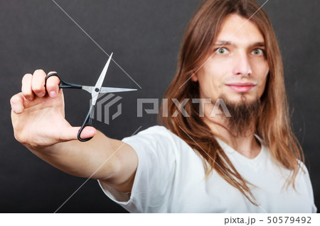 Hairstylist with scissors in hand Hairstylist with scissors in hand 50579492