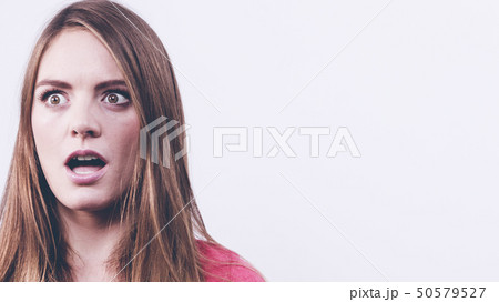 Woman looking shocked Woman looking shocked 50579527