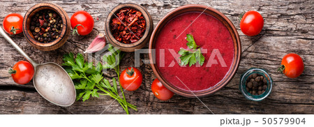 Tomato soup on wooden table 50579904