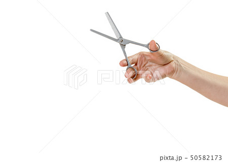 Woman hand is holding thinning scissors Woman hand is holding thinning scissors 50582173