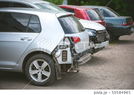 Broken and crashed modern cars after an accident on street Broken and crashed modern cars after an accident on street 50584965
