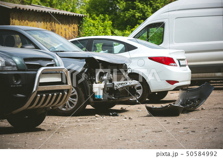 Broken and crashed modern cars after an accident on street Broken and crashed modern cars after an accident on street 50584992