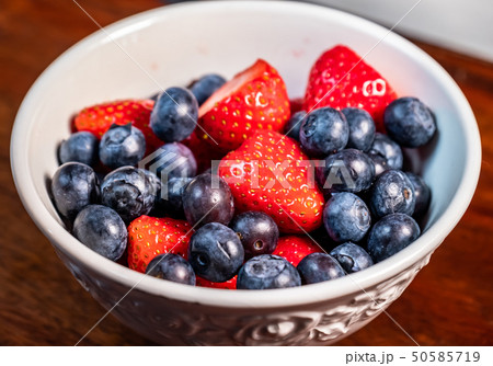 Strawberries and blueberries in white bowl ready to eat 50585719