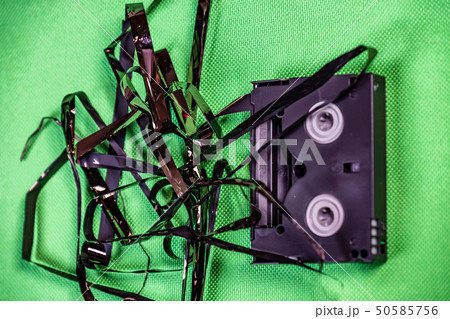 Tape pulled out from mini dv format video cassette tape Tape pulled out from mini dv format video cassette tape 50585756