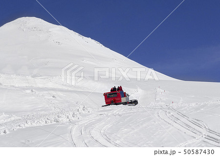 A group of tourists climb a snowcat on a Mount Elbrus 50587430