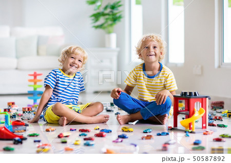 Kids play with toy cars. Children playing car toys 50587892