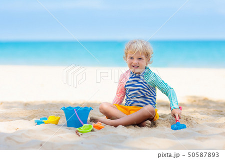 Kids playing on beach. Children play at sea. 50587893