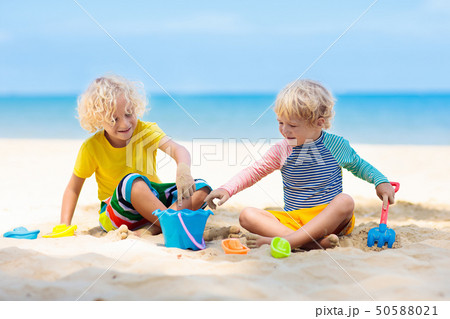 Kids playing on beach. Children play at sea. Kids playing on beach. Children play at sea. 50588021