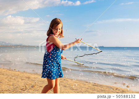 Kids blow bubble at beach. Child with bubbles Kids blow bubble at beach. Child with bubbles 50588132