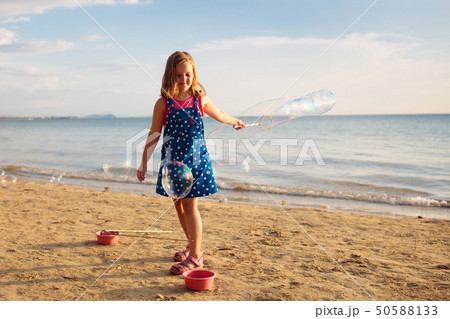 Kids blow bubble at beach. Child with bubbles Kids blow bubble at beach. Child with bubbles 50588133