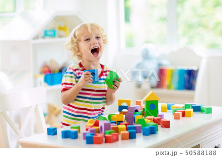 Kids toys. Child building tower of toy blocks. 50588188