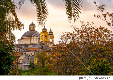 Ariccia - Rome suburb - Lazio - Italy Santa Maria church dome branches colorful sunset background Ariccia - Rome suburb - Lazio - Italy Santa Maria church dome branches colorful sunset background 50588537