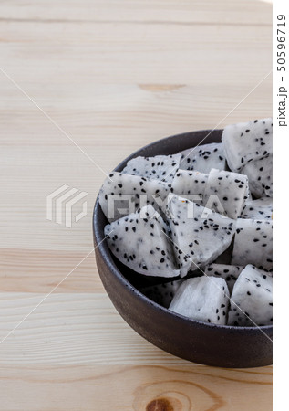 Fresh dragon fruits in black bowl on wooden 50596719