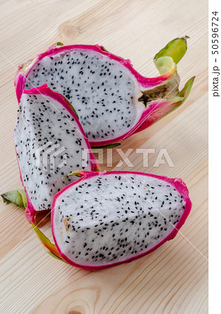 Fresh dragon fruits on wooden background. 50596724