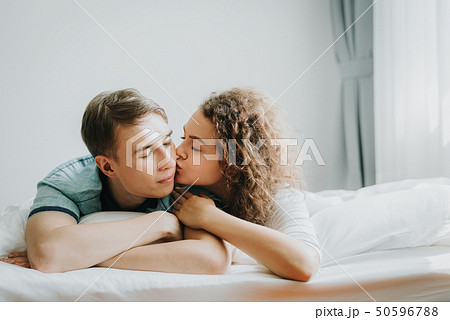 lovely couple in love kissing in bed lovely couple in love kissing in bed 50596788