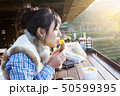 Asian girl eating sweet potato 50599395