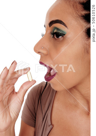 Woman swallowing a vitamin pill 50610526