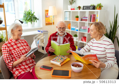 Nice aged people sitting around the table 50613313