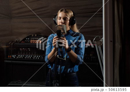 Young smiling blonde woman recording studio 50613595