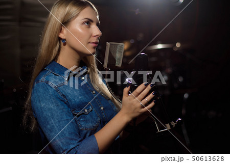 Close up of a singer recording a track in a studio 50613628
