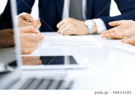 Group of business people and lawyers discussing contract papers sitting at the table, close-up 50614282
