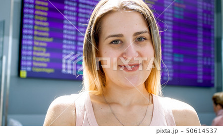 Portrait of smiling young woman waiting fro flight in international airport terminal 50614537