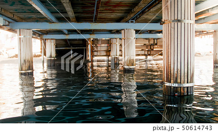 Image of sea waves and wooden colums under pier at sea shore 50614743