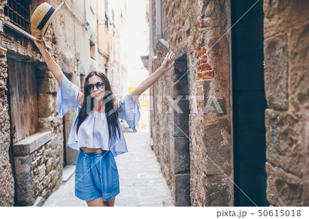 Happy young urban woman in european city. 50615018