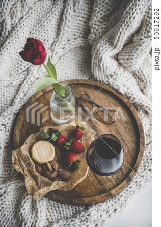 Glass of wine, different snacks and red tulip in 50617292