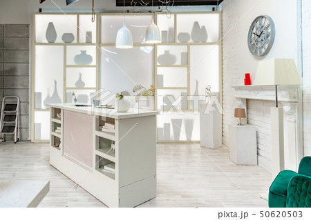 modern white studio. with a light stand in the middle, with a special light on the back wall. 50620503