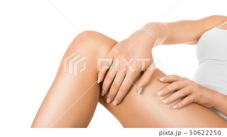 Female skin care. Woman applying moisturizer on her perfect legs, isolated on white background 50622250