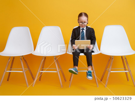 baby girl working on a tablet baby girl working on a tablet 50623329