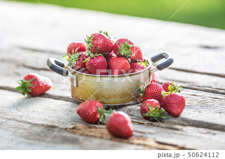 Fresh ripe strawberries in vintage kitchen pot on Fresh ripe strawberries in vintage kitchen pot on 50624112