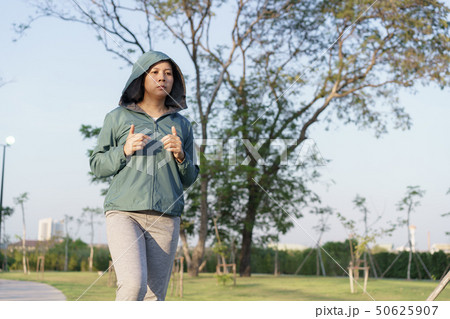Asian women jogging in the morning garden Asian women jogging in the morning garden 50625907