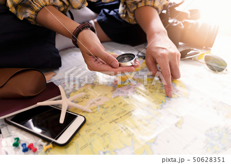 Hand to planning vacation trip and accessories for 50628351