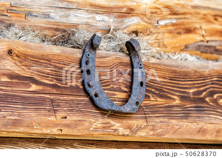 Old rusty horseshoe hanging on the wall Old rusty horseshoe hanging on the wall 50628370
