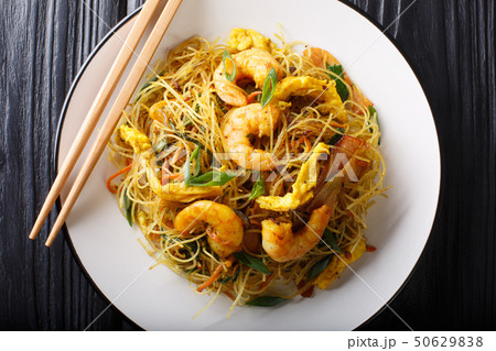 Spicy fried rice noodles with sausage, shrimps and 50629838