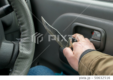 View of the knife in the hand of the driver 50632516
